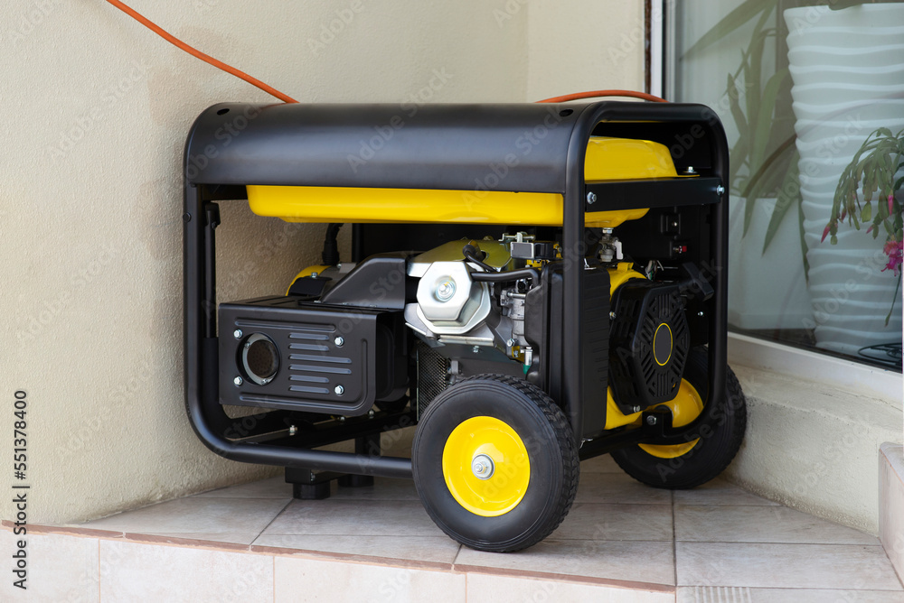 Portable electric generator running in the cold winter.Energy genocide. Power outage as a result of missile strikes by Russia on energy facilities of Ukraine. Small business use gasoline generators.