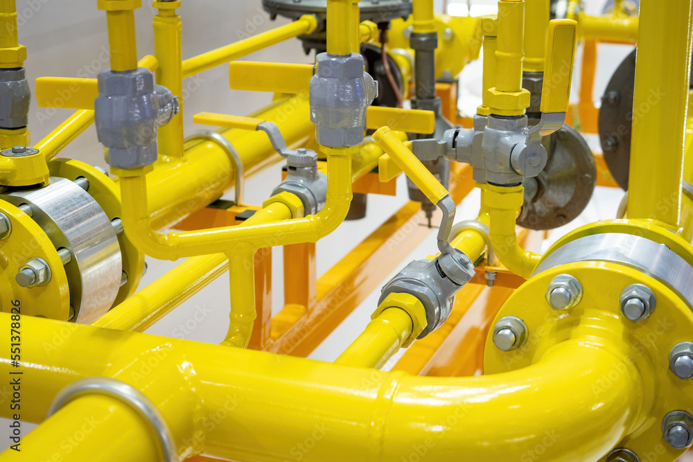 Yellow pipeline. Fragment of gas pipeline with flow control valves. Tangled pipes of different diameters. Pipes for gas transmission. Pipeline for supply of chemical products. Gas compressor unit Yellow pipeline. Fragment of gas pipeline with flow control valves. Tangled pipes of different diameters. Pipes for gas transmission. Pipeline for supply of chemical products. Gas compressor unit