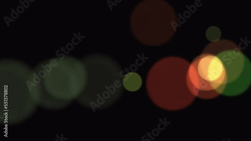 Floating multi-colored circles with bokeh effect on a black transparent background with Alpha Channel. Abstract cosmic background. Background for promo and advertising. 4K video footage. 3D animation