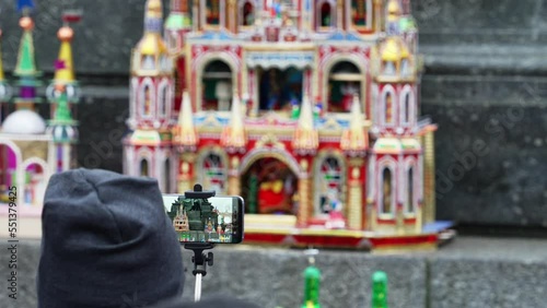 Tourist shoots on smartphones annual creative competition of miniature models of attractions of Krakow on the eve of Christmas, a traditional exhibition of hand works in the center of Krakow