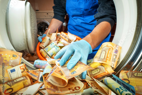 Euro money banknotes in a washing machine, closeup inside view. Concept of corruption, money laundering and finance crisis.