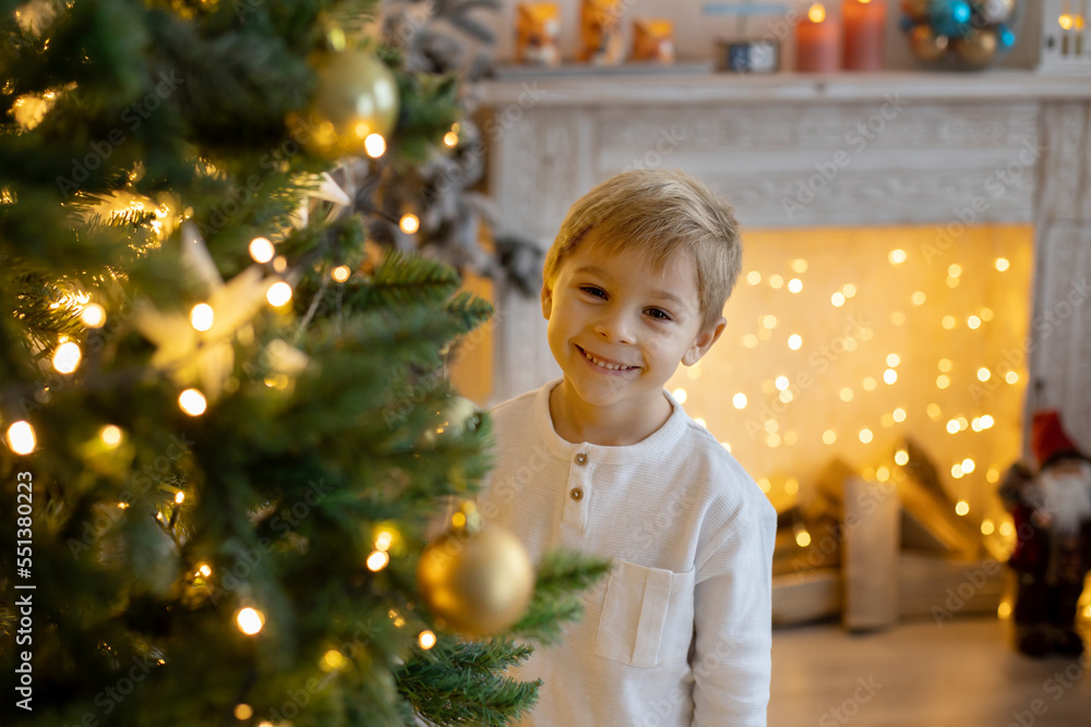 Cute preschool child, blond boy with pet dog, playing in decorated Christmas room Cute preschool child, blond boy with pet dog, playing in decorated Christmas room