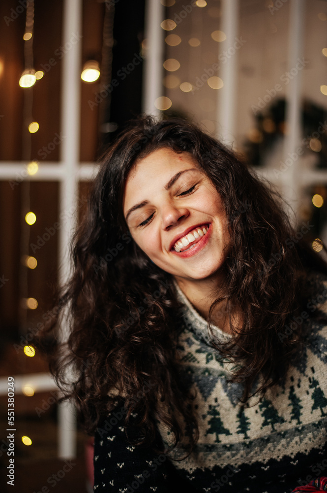 Girl is smiling and show emotions in new year location 