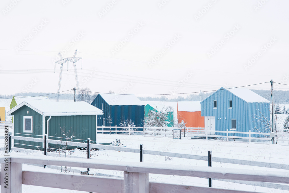 Scandi colorful wooden house on winter background.Vintage design. 