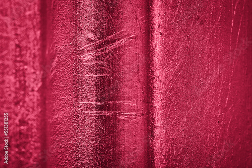 Relief wall as abstract background in metallic red viva magenta color. photo