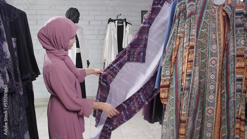 Wallpaper Mural Concept of shopping in Muslim countries. A young Muslim woman choosing clothes at the store Torontodigital.ca
