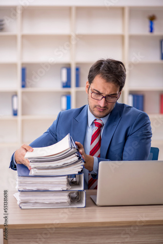 Young male employee working in the office