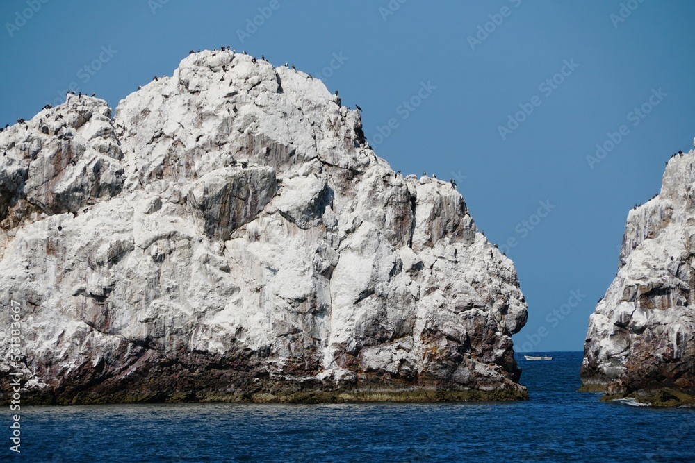 The white rock island in the middle of the ocean on a sunny day near Mazatlan, Mexico