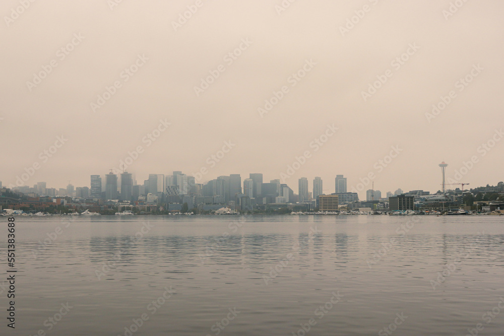 View of Seattle skyline and Space Needle from across Lake Union at Gasworks Park with hazy smoky skies ranking as world's worst air quality