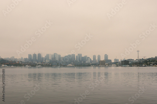 View of Seattle skyline and Space Needle from across Lake Union at Gasworks Park with hazy smoky skies ranking as world's worst air quality © ShakedN