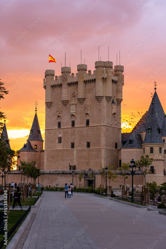 Obraz premium View of the main Tower of the Alcazar de Segovia with Spanish Flag in the Air