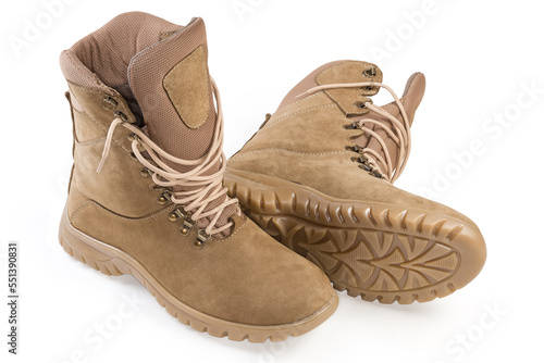 Pair of beige leather combat boots on a white background