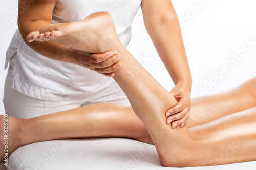Masseur makes anti-cellulite massageon the legs in the spa. Overweight treatment, body sculpting.Cosmetology and massage concept.