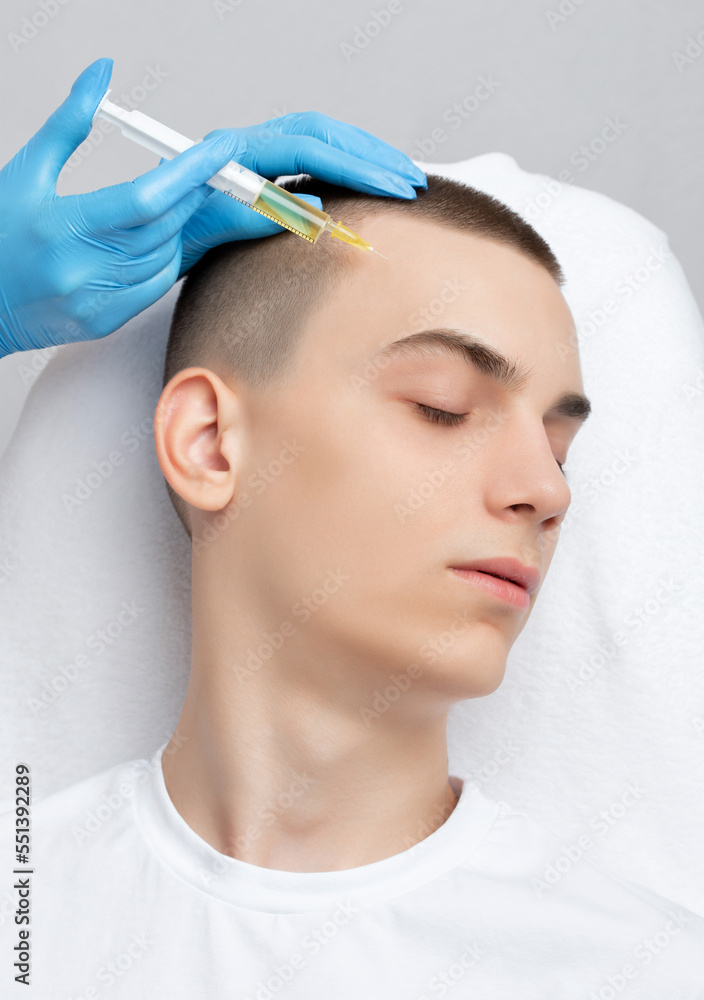 Cosmetologist does prp therapy of a handsome guy in beauty salon. Cosmetology concept. Cosmetologist does prp therapy of a handsome guy in beauty salon. Cosmetology concept.