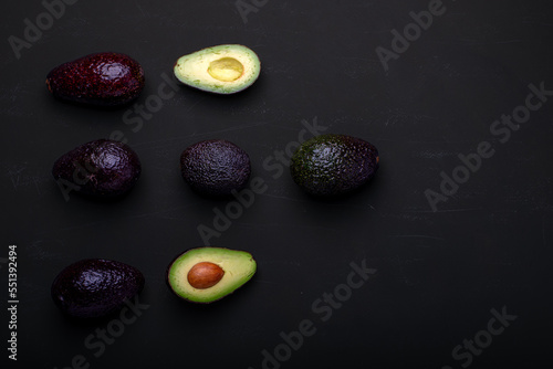 Fresh avocado on a black background. Top view. Free space for your text.