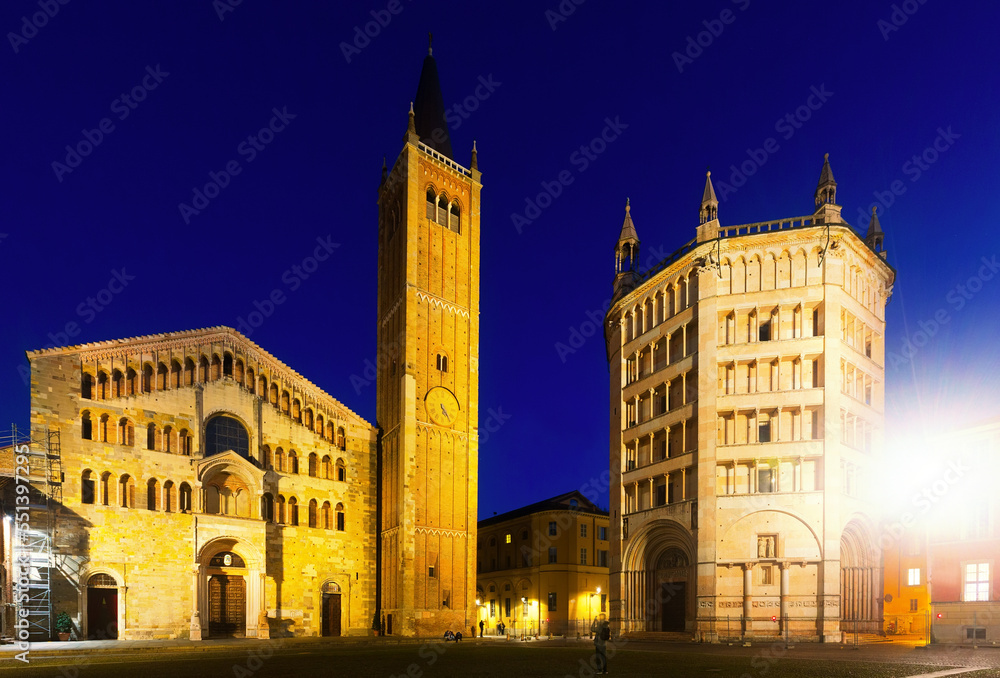 Parma cathedral and baptistery illuminated at dusk and Piazza Duomo in Italy