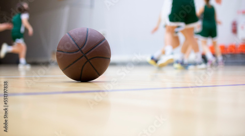 A basketball on the wooden floor as background. Team sport concept. Horizontal sport poster, greeting cards, headers, website