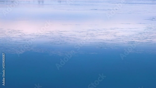 Early winter, freeze-up, ice formation on the northern river. Grease ice (ice fat) is floating downstream, which means that the river will freeze over in a couple of days, fast ice photo