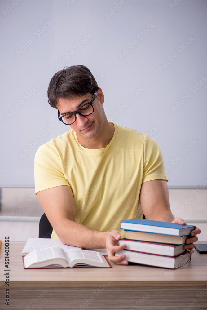 Young male student sitting in the classroom Young male student sitting in the classroom