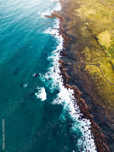 Vertical photo, aerail view of waves crushing on the shore - Iceland
