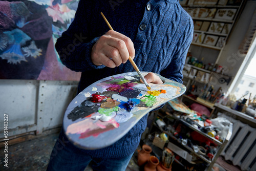 artist in his studio with brush