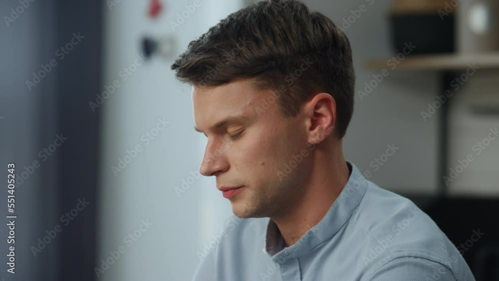 Portrait thoughtful man working at home. Businessman doing job tasks in kitchen. Portrait thoughtful man working at home. Businessman doing job tasks in kitchen.