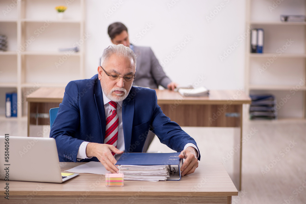 Two male colleagues sitting in the office Two male colleagues sitting in the office