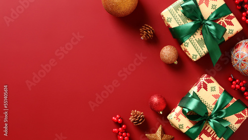 Christmas gift boxes and festive decorations in corners frame on red background. Xmas banner design, Happy New Year greeting card template.
