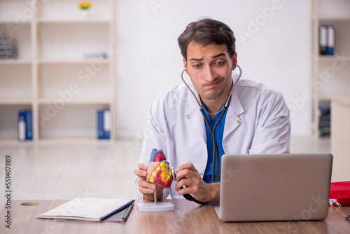 Young male doctor cardiologist working in the clinic