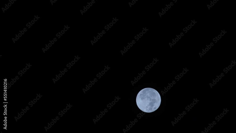 Full moon moving against dark night sky Full moon moving against dark night sky