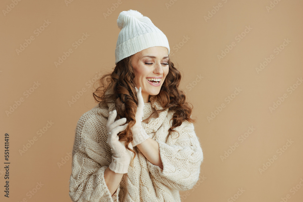 smiling stylish woman against beige showing hair smiling stylish woman against beige showing hair