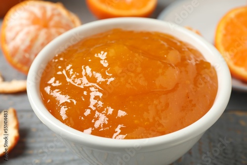 Tasty tangerine jam in bowl on table  closeup