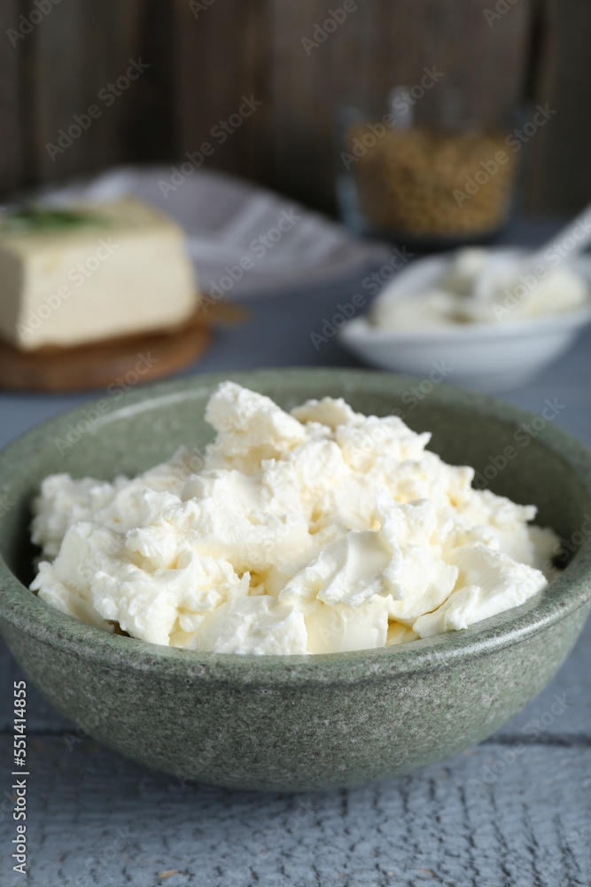 Delicious tofu cream cheese in bowl on grey wooden table