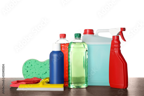 Many different car wash products on wooden table against white background