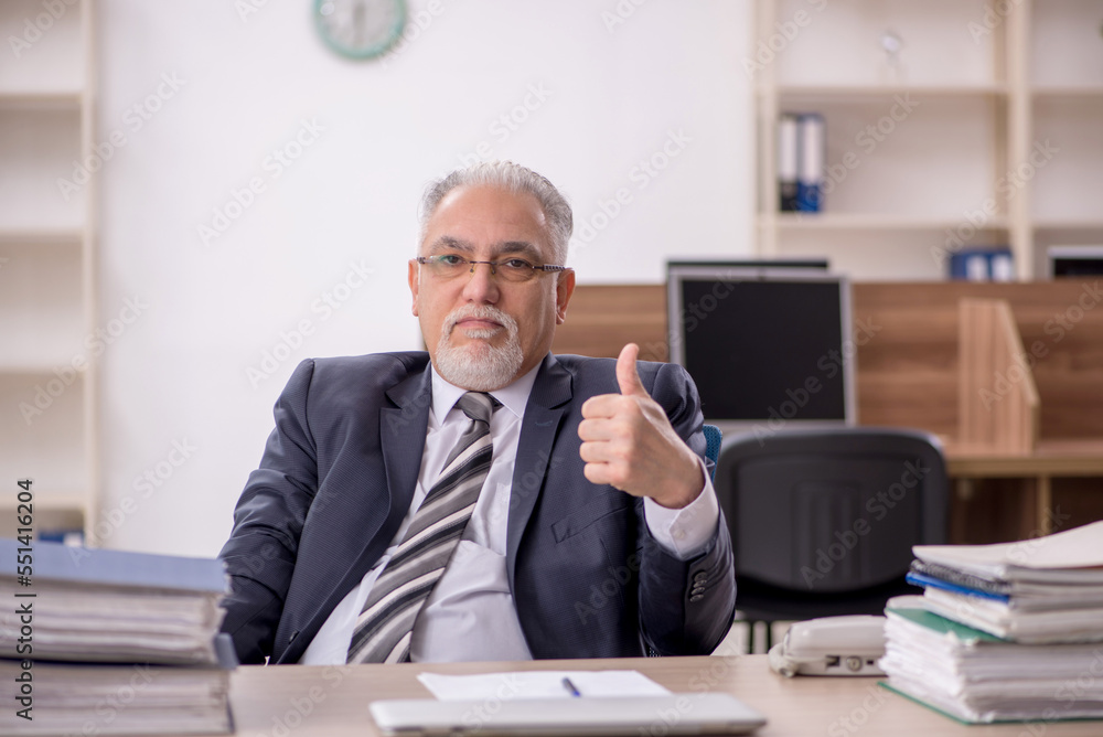 Old male boss employee working in the office Old male boss employee working in the office