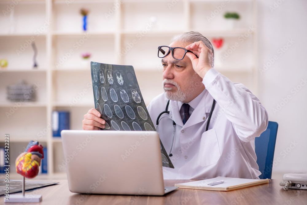 Old male doctor radiologist working in the clinic Old male doctor radiologist working in the clinic