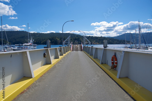 Small island ferry terminal surrounded by boat on a sunny summer day. © Alain Bechard