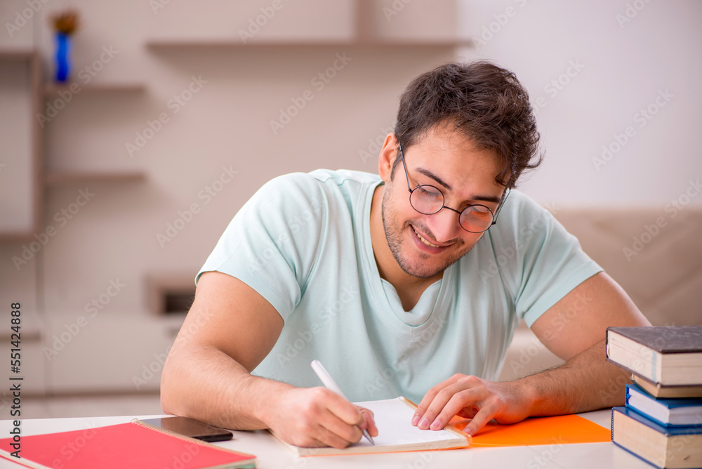 Young male student preparing for exams at home Young male student preparing for exams at home