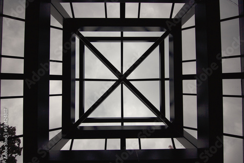 Symmetrical glass structured ceiling of a building viewed from the inside. © Alain Bechard