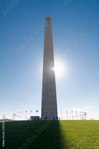 washington dc, Washington . A ray of sun cuts through George Washington's monument on a sunny day with a blue cloudless sky background.