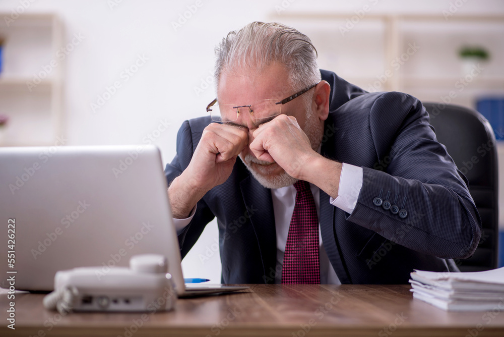 Old male employee and too much work in the office Old male employee and too much work in the office