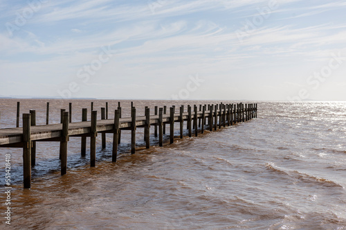 The symmetry of the wooden pier in the Itapu   park  Guaiba river