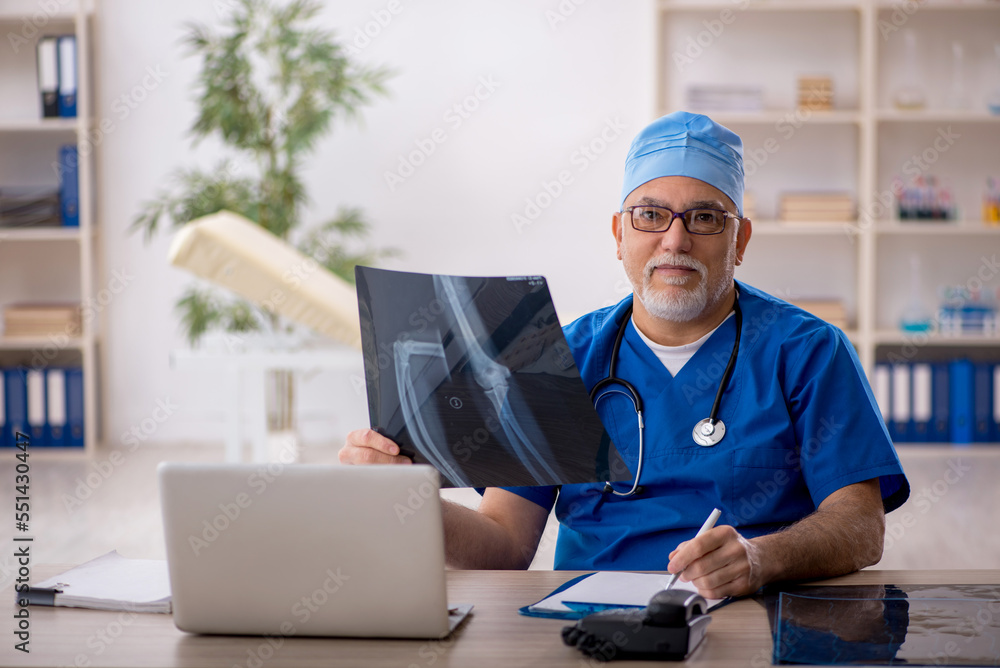Old male doctor radiologist working in the clinic Old male doctor radiologist working in the clinic
