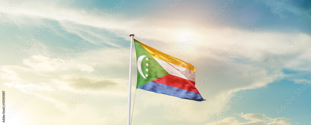 Waving Flag of Comoros with beautiful Sky.
