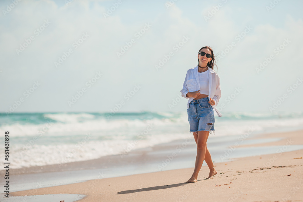 Young happy woman on the beach