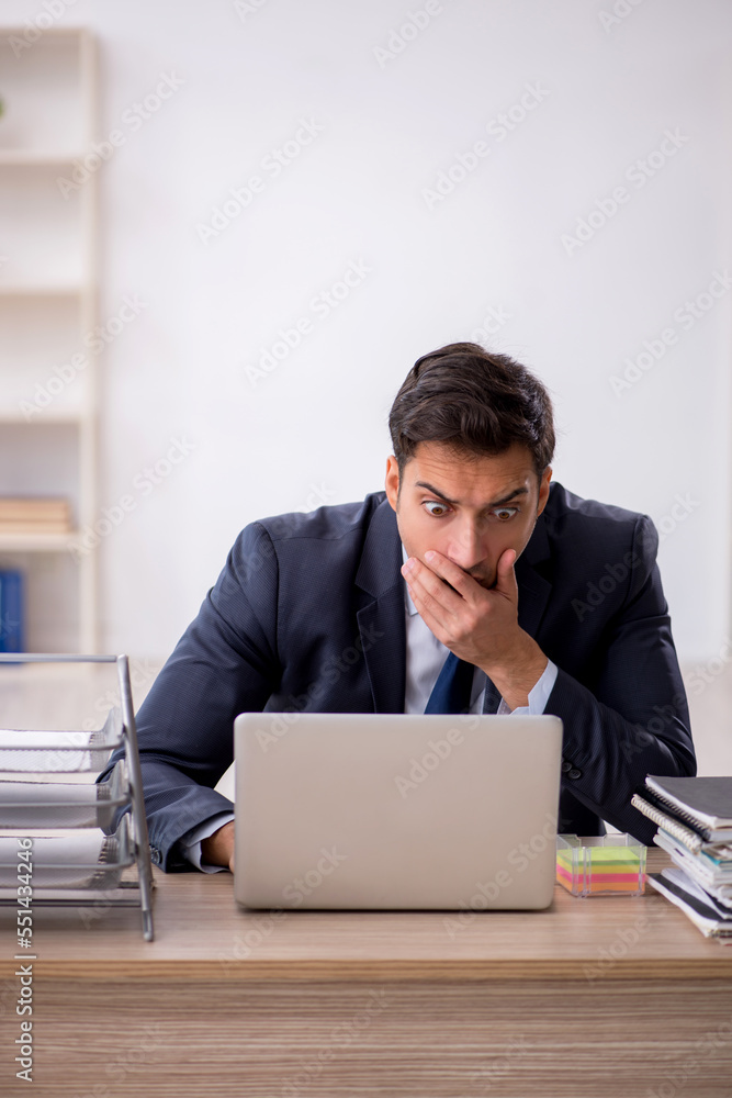 Young male employee working in the office Young male employee working in the office