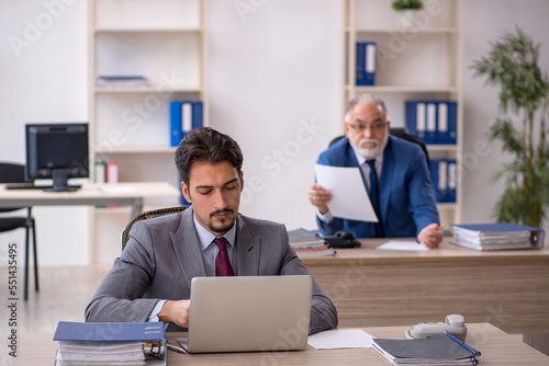 Two male colleagues working in the office