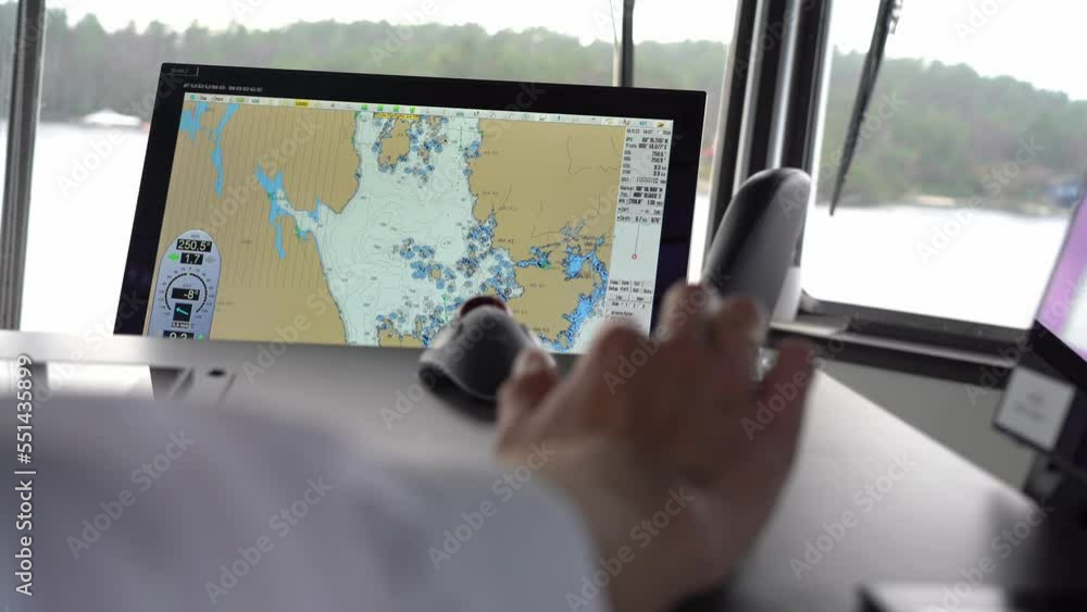 Ship captain uses computerized chart while navigating ship. Over ...