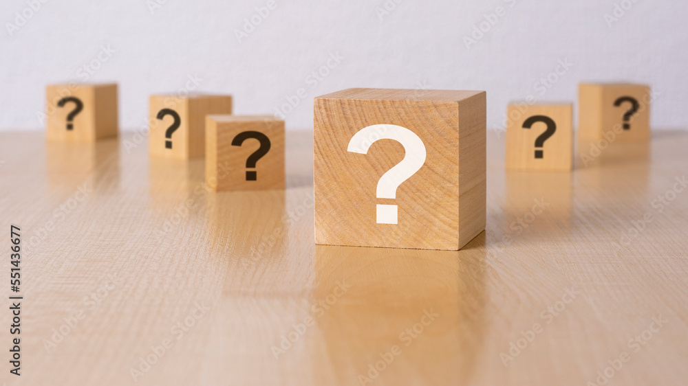 front view on many wood cubes with question marks. many question arising concept front view on many wood cubes with question marks. many question arising concept