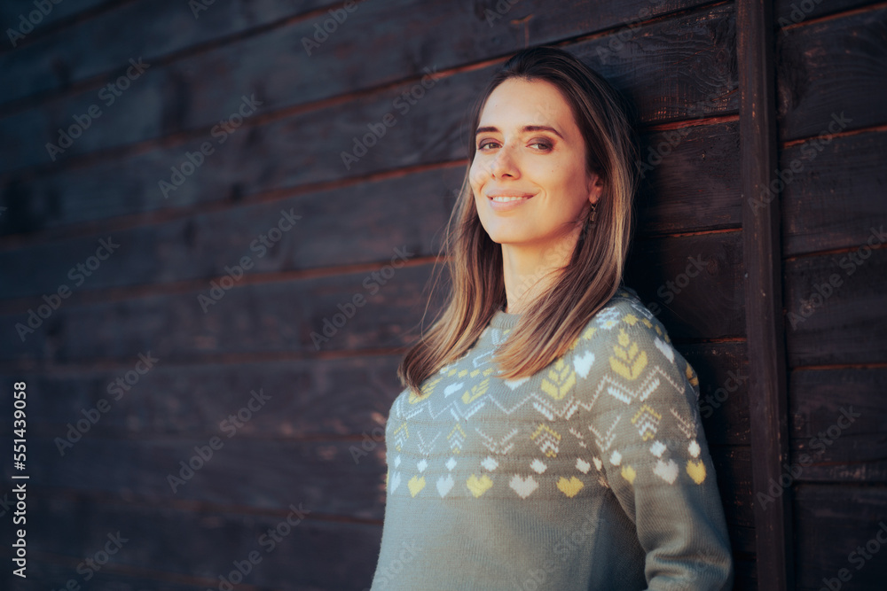 Naklejka premium Portrait of an Optimistic Woman Smiling Wearing Cool Sweater. Happy charismatic lady in knitwear fashion item 